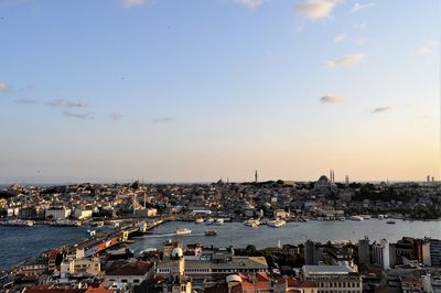 High angle view of townscape by sea against sky