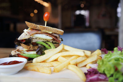 Close-up of burger and vegetables on table