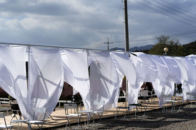 Clothes drying on clothesline against sky