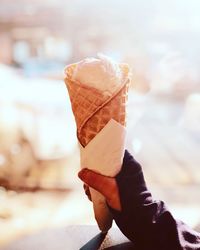 Close-up of hand holding ice cream cone