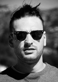 Close-up portrait of young man wearing sunglasses