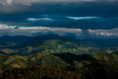 Scenic view of mountains against storm clouds