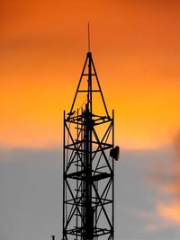 Low angle view of silhouette electricity pylon against sky during sunset