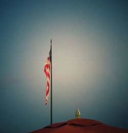 Low angle view of flag against clear sky