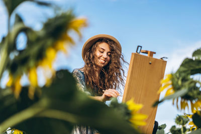 Low angle view of woman against sky