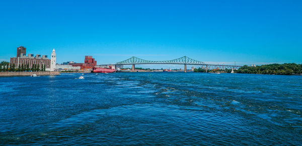 View of bridge over sea against blue sky