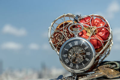 Close-up of clock against sky