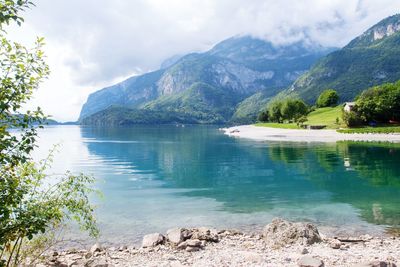 Scenic view of lake and mountains against sky