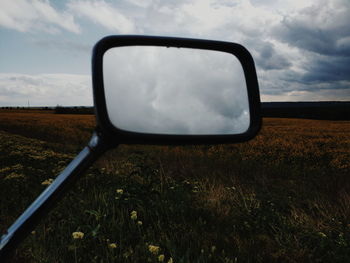 Reflection of sky on side-view mirror