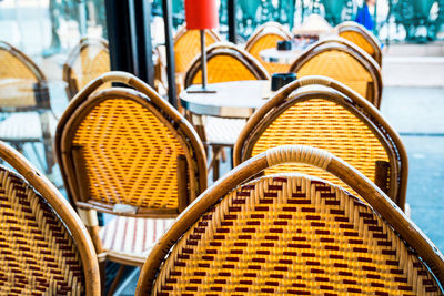 Close-up of empty chairs and table at cafe