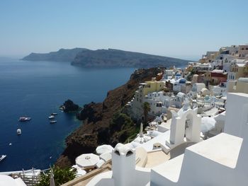 High angle view of town by sea against clear sky