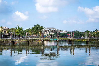 Scenic view of lake by building against sky