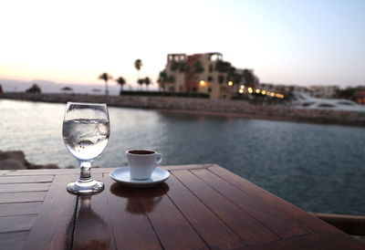 Turkish coffee cup with glass of water on sea view