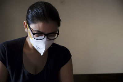Portrait of woman wearing eyeglasses at home