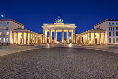 Panorama of the famous illuminated brandenburg gate in berlin at night with no people