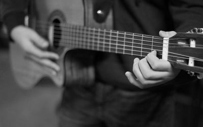 Cropped image of man playing guitar