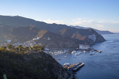 High angle view of sea and mountains against sky