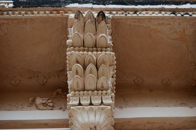 Close-up of cross against wall in old building