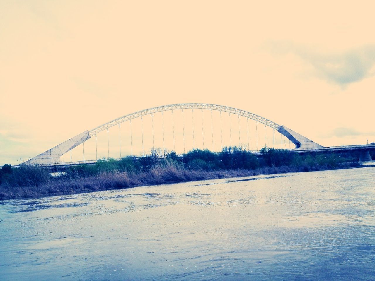 sky, connection, built structure, bridge - man made structure, architecture, water, nature, cloud - sky, outdoors, river, low angle view, beach, transportation, no people, tranquility, engineering, tranquil scene, day, scenics, sand