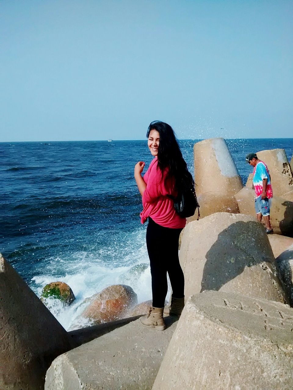 sea, water, lifestyles, full length, leisure activity, clear sky, casual clothing, young adult, standing, beach, horizon over water, young women, person, copy space, shore, portrait, looking at camera, front view