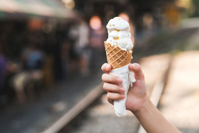 Close-up of hand holding ice cream cone