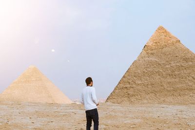 Man looking at pyramids