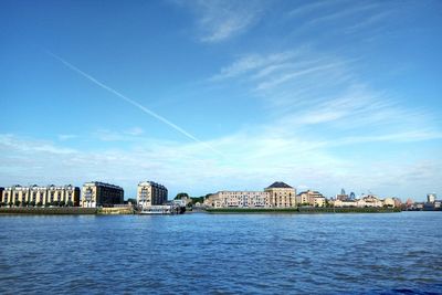 Scenic view of residential district against blue sky