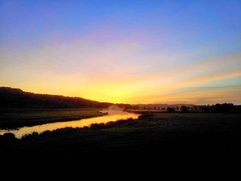 Scenic view of lake at sunset