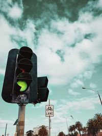 Low angle view of road sign against sky