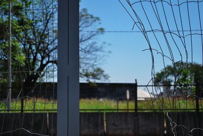 Close-up of metal fence against sky