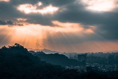 Scenic view of silhouette mountains against sky at sunset