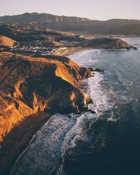 Aerial view of sea and mountain against sky