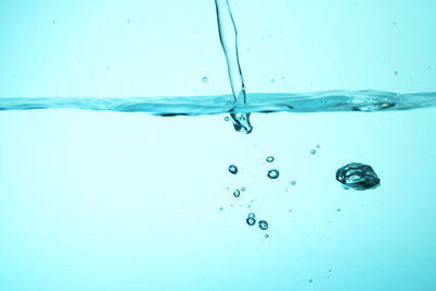Close-up of water drops against blue background