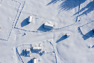 Snow covered remote village, homestead in the mountains. aerial drone view