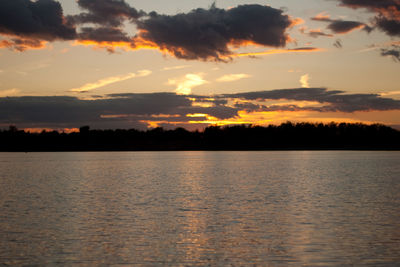 Scenic view of lake against orange sky