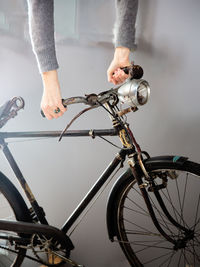 Low section of man with bicycle on road