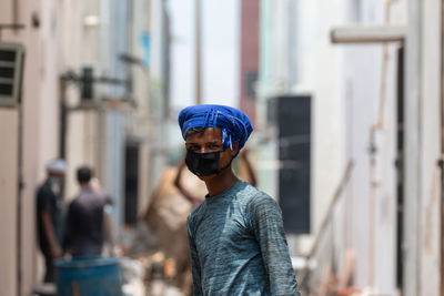 Portrait of man standing in city