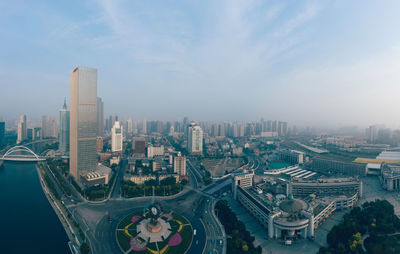 High angle view of city buildings against sky