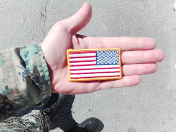 Low section of man holding flag