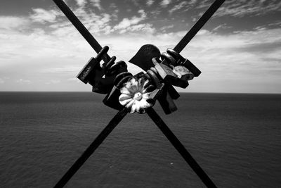 Traditional windmill in sea against sky