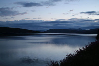 Scenic view of lake against cloudy sky