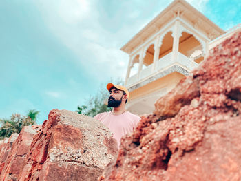 Low angle view of man standing against building