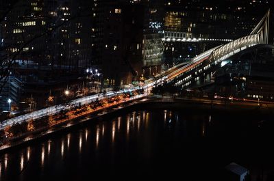 Illuminated bridge in city at night