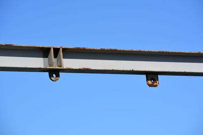 Low angle view of metallic structure against clear blue sky