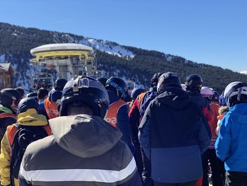 Rear view of people standing on mountain road