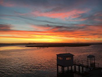 Scenic view of sea against orange sky