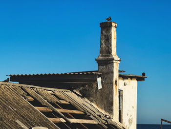 Low angle view of building against clear blue sky