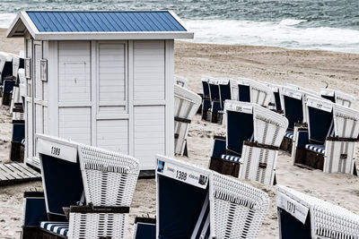 Chairs on beach against sea