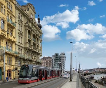 View of city street and buildings against sky