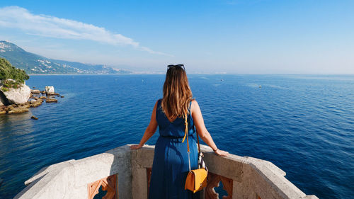 Rear view of woman looking at sea